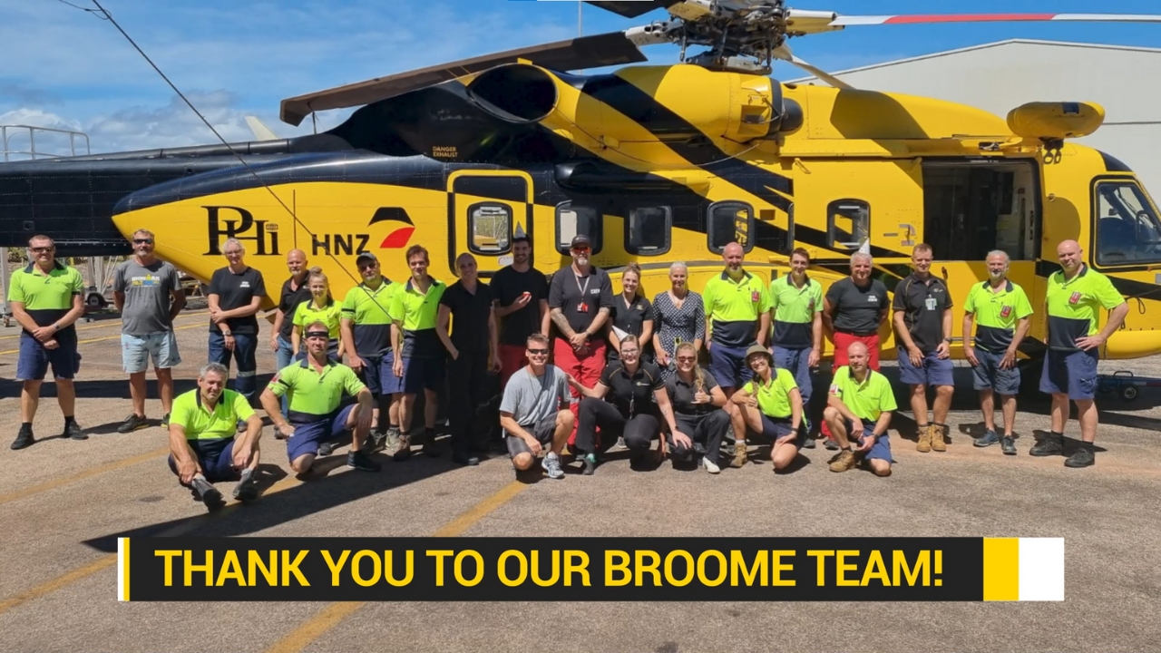 PHI Broome team photo in front of PHI Black & Yelllow helicopter