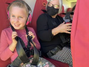 Smiling young girl and adult woman as passengers in helicopter
