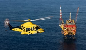 PHI helicopter flying near offshore oil rig