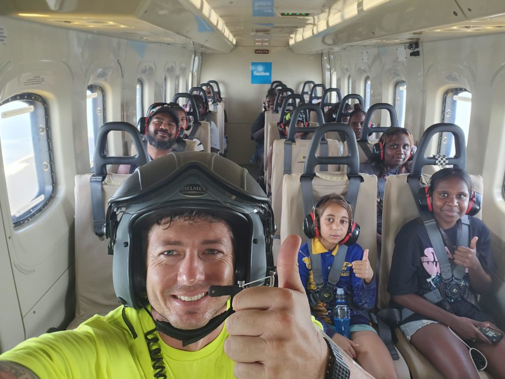 PHI search and rescue crewperson smiling with thumbs up with passengers rescued from Kimberley flooding
