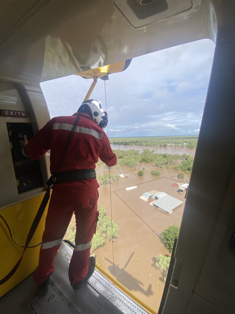 PHI SAR crewperson overlooking flooded landscape from historic Kimberley floods