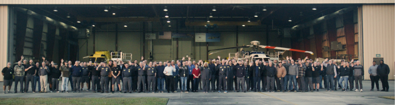 PHI MRO team group photo standing outside of hangar